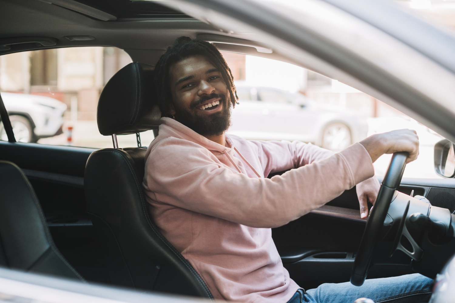 Smiling learner driver at the wheel