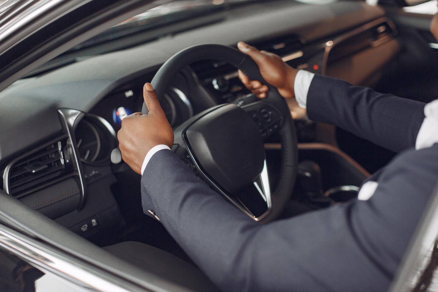 Driver's hands on the steering wheel